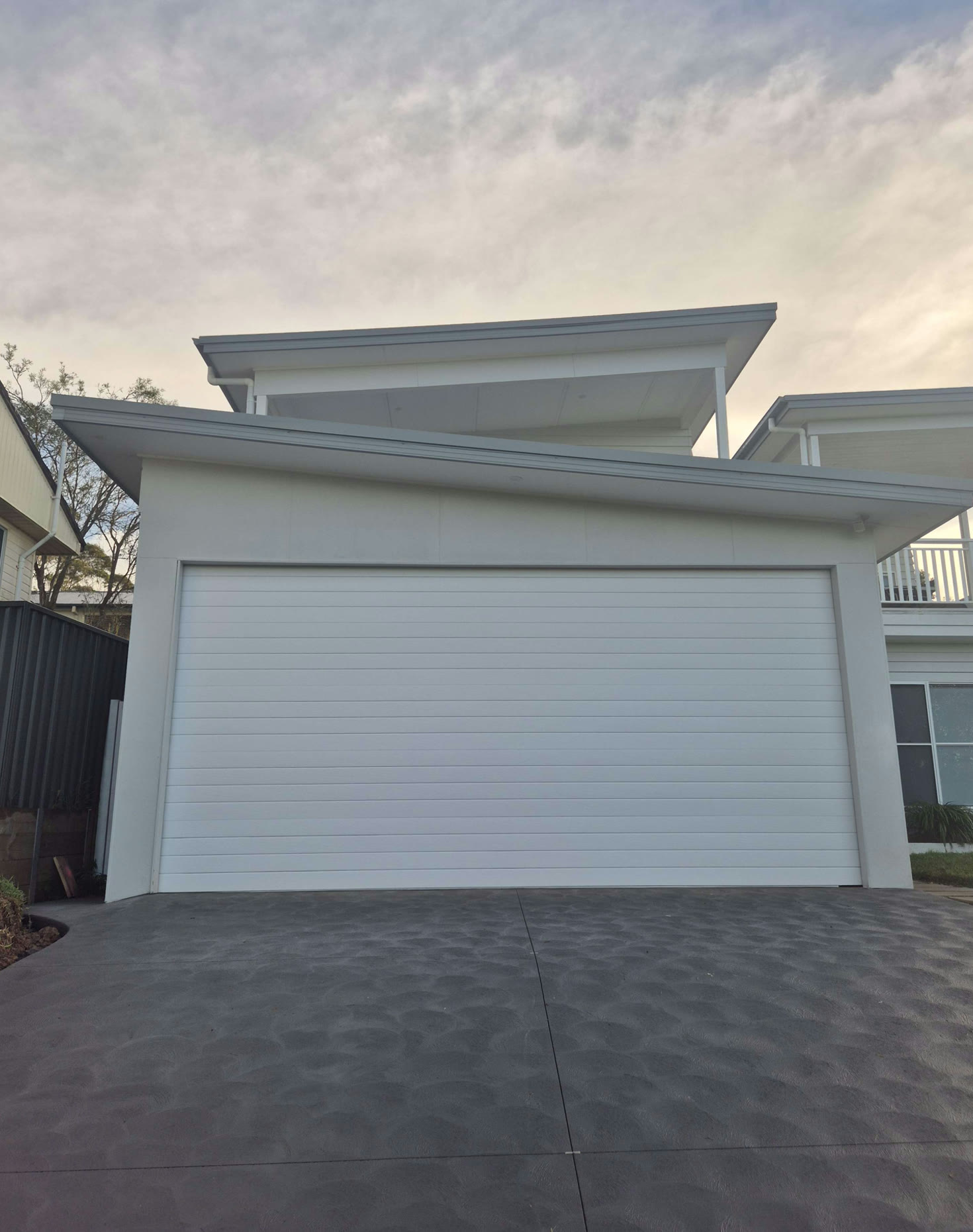 After — the same garage door finished in crisp white